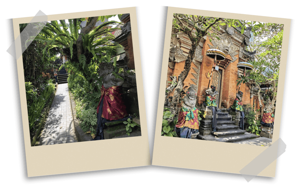 Traditional entrance and Balinese architecture in Ubud, Bali, featuring guardian statues draped in colorful fabrics and intricately carved ornamental doors